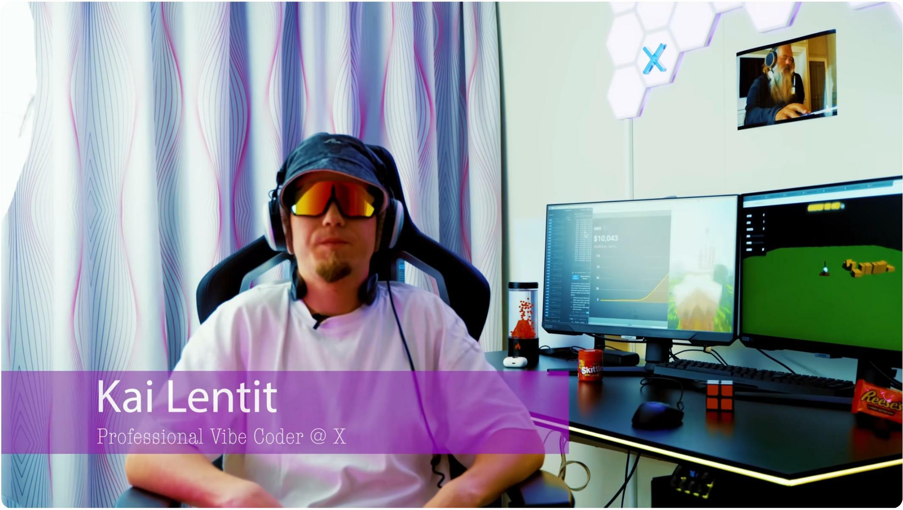 Auto-generated description: A person wearing headphones and sunglasses is seated at a gaming setup with multiple monitors, surrounded by gaming and tech accessories.